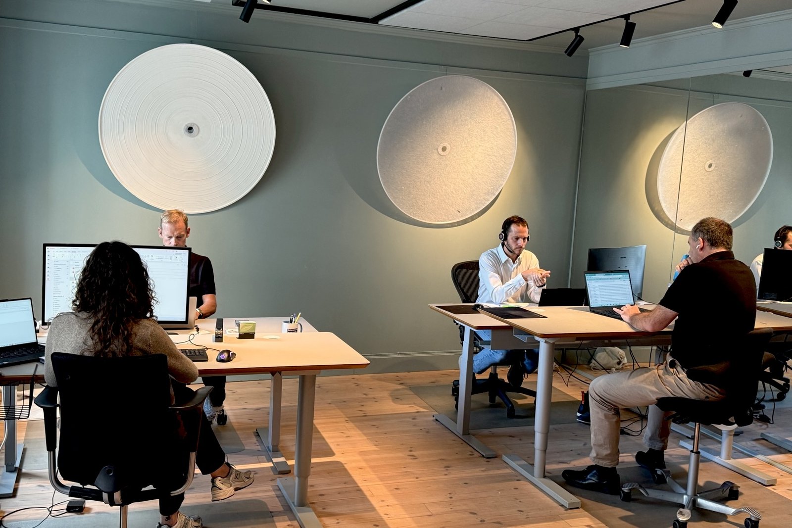 Colleagues at their desks in the WayMark Oslo office